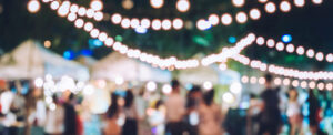 music festival with blurred people and string lights