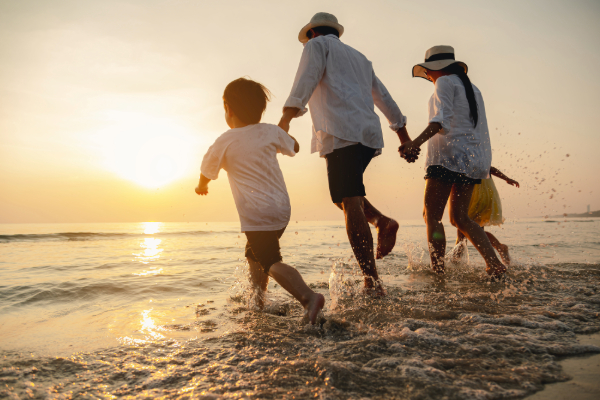 family running on the beach
